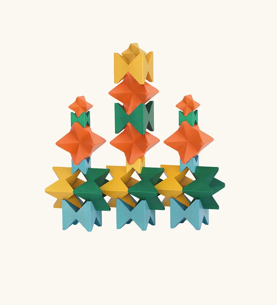 Naef Spiel signature stamped edition cubes stacked up to form three towers on a long base.