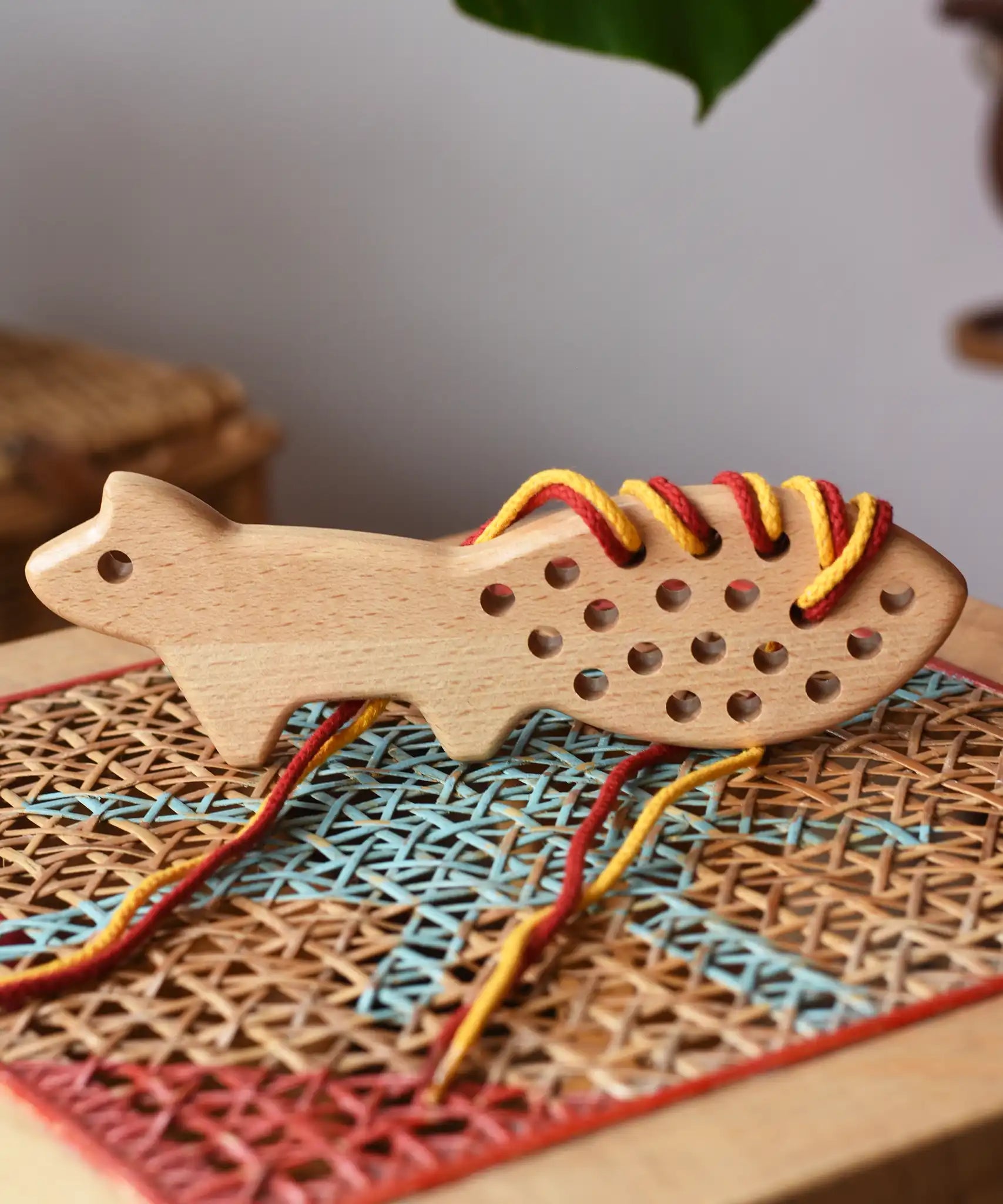 Bajo natural lacing fox placed on a rattan stool in the Babipur playroom.