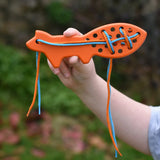 Bajo orange lacing fox wooden toy in a child's hands.