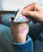 Butterfly tattoo from the Namaki butterfly face painting kit applied to a child's hand.