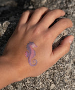 Seahorse tattoo from the Namaki mermaid face painting kit applied to a child's hand.