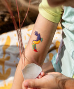 Toucan tatoo from the Namaki tiger face painting kit applied to a child's arm.