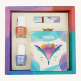 An open cardboard box for the Namaki fairy moonlight make up set which includes a blue and orange nail polish, a eye shadow set and a lipgloss on a cream background.