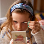A child applying the Namaki Natural Eyeshadows Palette - Spring