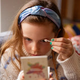A child applying the Namaki Natural Eyeshadows Palette - Spring