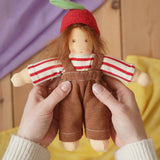 Nanchen apple child Waldorf doll  Anna in an adults's hand in the Babipur playroom.