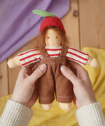 Nanchen apple child Waldorf doll  Anna in an adults's hand in the Babipur playroom.
