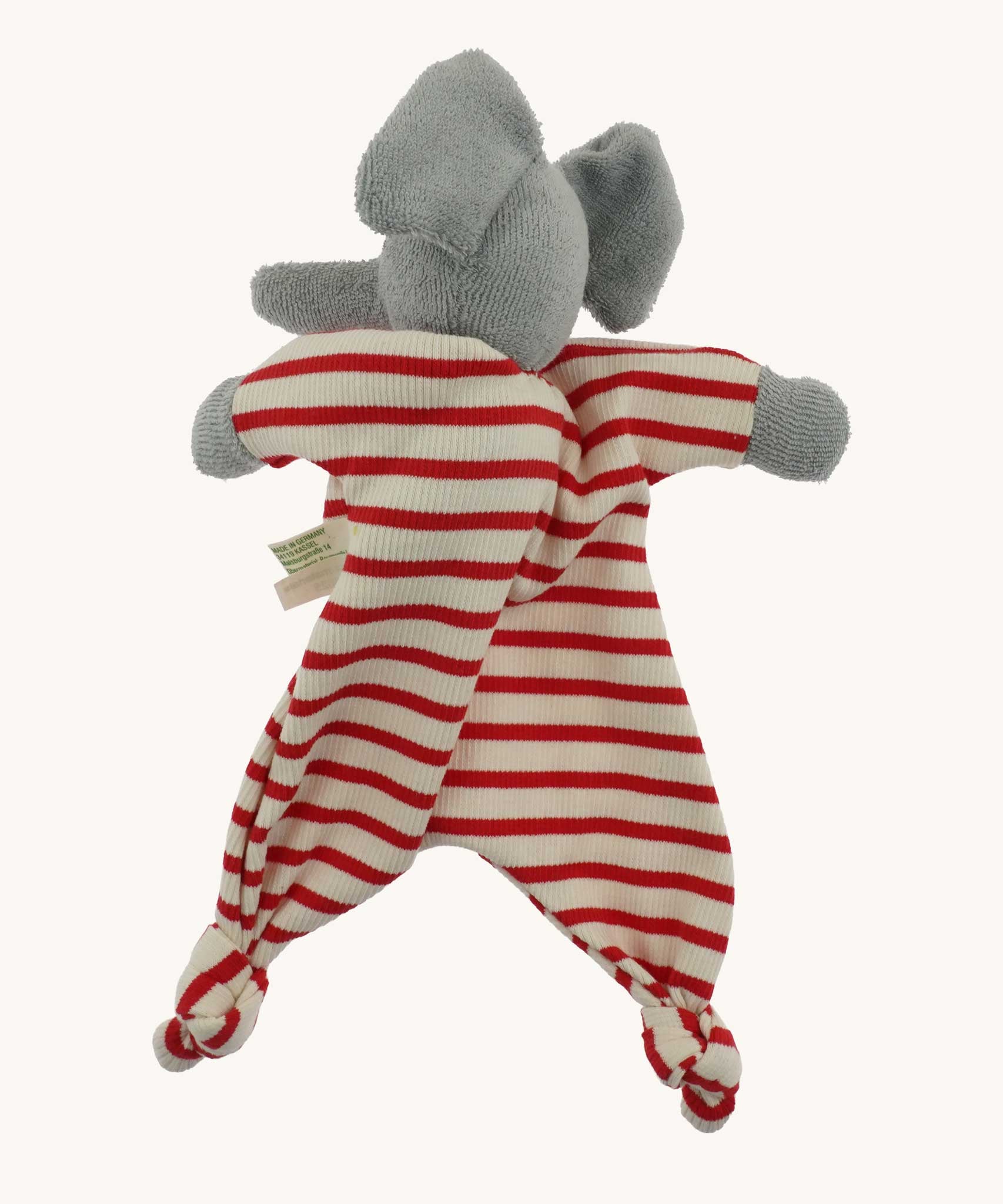The back of a Nanchen elephant baby comforter soft toy. The grey elephant has a red and white striped body.