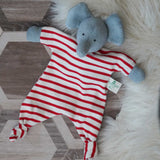 A Nanchen elephant baby comforter soft toy placed on a rug on a wooden floor.