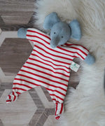 A Nanchen elephant baby comforter soft toy placed on a rug on a wooden floor.