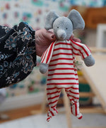 A close up of the Nanchen elephant baby comforter soft toy shown in an adult's hand.
