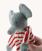 A close up of the Nanchen elephant baby comforter soft toy's trunk. The grey elephant has a red and white striped body.
