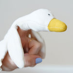 A close up of the goose's head on the Nanchen white goose baby comforter. There is a small pocket in the material allowing the goose to be used as a puppet.
