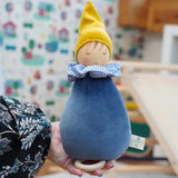 A close up of a Nanchen Dream King Frog Lullaby Music Doll in a child's hand. A musical Waldorf doll, made from organic cotton and sheep's wool. 