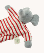 A close up of the Nanchen elephant baby comforter soft toy. The grey elephant has a red and white striped body.