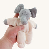 A Nanchen Elephant Teddy Rattle being held in an adult's hand.