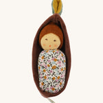 Nanchen Oak Baby Waldorf Doll - Floral. A little organic grasping doll in a brown velvet cradle on a cream background.