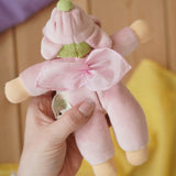 Back of the Nanchen flower fairy Waldorf rattle doll in an adult's hands in the Babipur playroom.