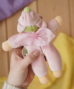 Back of the Nanchen flower fairy Waldorf rattle doll in an adult's hands in the Babipur playroom.