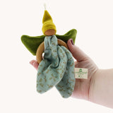 The Nanchen green Flower Fairy Ring Grasper toy shown in an adult's hand. A soft toy attached to a wooden ring that can be used as a grasping toy or hung up.