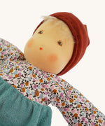 A close up of the face of the sage coloured Nanchen Forest Child Waldorf organic, handcrafted Doll.