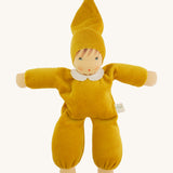 A beautiful Nanchen Waldorf Nani Doll, with a pretty hand painted face. This hand crafted doll toy has a gold fabric, soft body with a small white collar and gold pointy hat. On a cream background