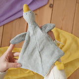 Nanchen grey goose baby comforter shown on an adult's hand in the Babipur playroom. 