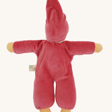 The back of a Nanchen Nani Waldorf Doll in pink. The dolls has a pink velour feel outfit with a matching pink hat. 