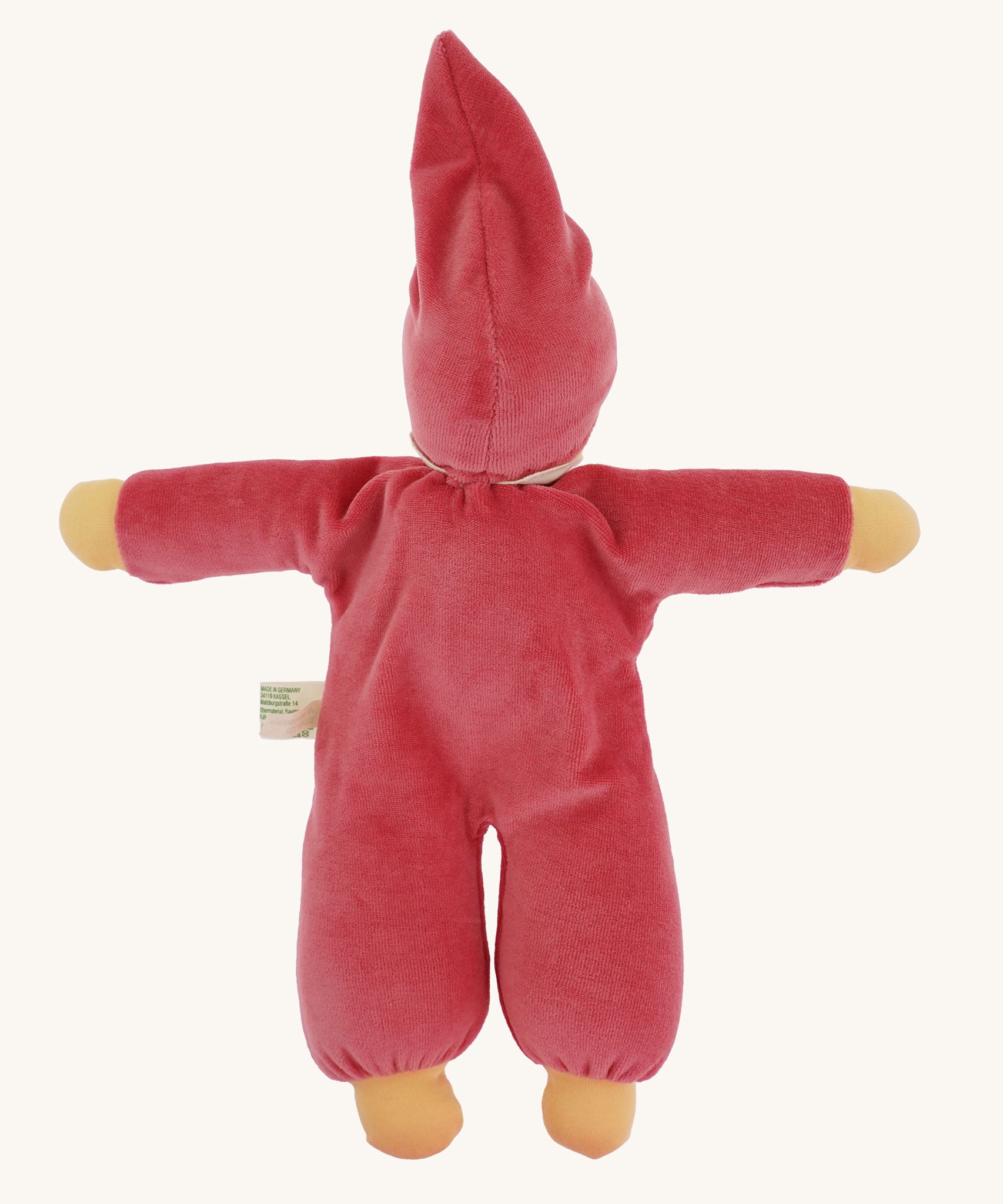 The back of a Nanchen Nani Waldorf Doll in pink. The dolls has a pink velour feel outfit with a matching pink hat. 