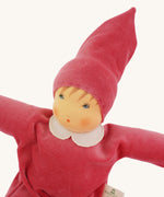 A close up of the face of the Nanchen Nani Waldorf Doll with pink outfit and hat.