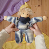 Nanchen King Karl Waldorf doll in an adult's hands in the Babipur playroom. 