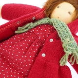 A close up of the popper closure on the  Nanchen handcrafted Little Red Riding Hood Waldorf doll's red coloured coat.