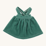 Nanchen Waldorf Doll - Lotte's green pinafore dress on a cream background 