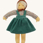 Nanchen Waldorf Doll - Lotte, an organic doll wearing a floral blouse, green cord pinafore dress and a brown bonnet. 