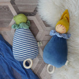 Two Nanchen Lullaby Music Dolls. Musical Waldorf dollS, made from organic cotton and sheep's wool. The blue dream king and frog lullaby dolls have been placed on a rug on a wooden floor. 