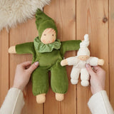 Nanchen Natur Waldorf Nani doll in forest green and a natural pimpel dolls in an adult's hands in the Babipur playroom. 