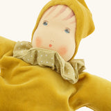 Close up of teh facicil features on the Nanchen Natur Nani Waldorf doll in gold.