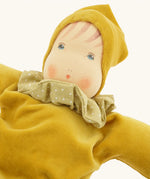 Close up of teh facicil features on the Nanchen Natur Nani Waldorf doll in gold.