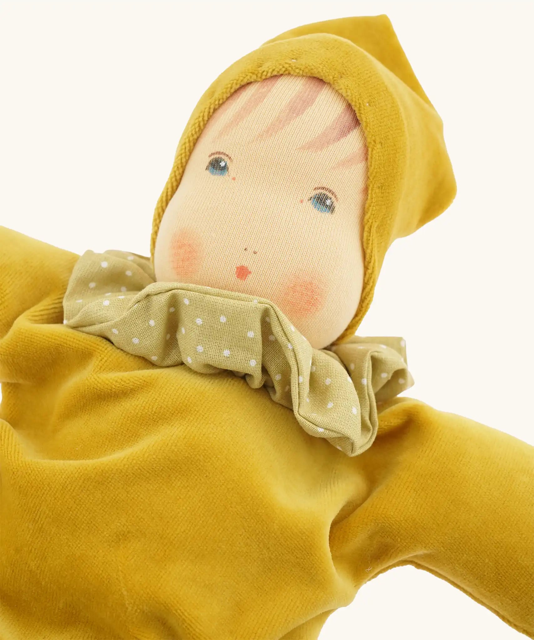 Close up of teh facicil features on the Nanchen Natur Nani Waldorf doll in gold.