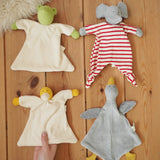 Four Nanchen Natur baby comforters , frog, elephant, duck and goose placed on a wooden floor in the Babipur playroom. 