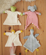 Four Nanchen Natur baby comforters , frog, elephant, duck and goose placed on a wooden floor in the Babipur playroom. 