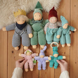 Collection of Nanchen Natur handmade Waldorf dolls placed on a wooden floor in the Babipur playroom. 