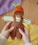 Nanchen Otto Orange child Waldorf doll in an adult's hand in the Babipur playroom.