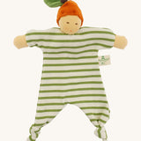 Front view of the Nanchen Orange Baby Comforter, a handcrafted doll with a natural-toned face and an orange velour fruit-inspired hat topped with a green leaf. The body is made of green and white striped organic cotton terry with knotted feet and extended arms, and includes a "Nanchen Natur" brand tag.
