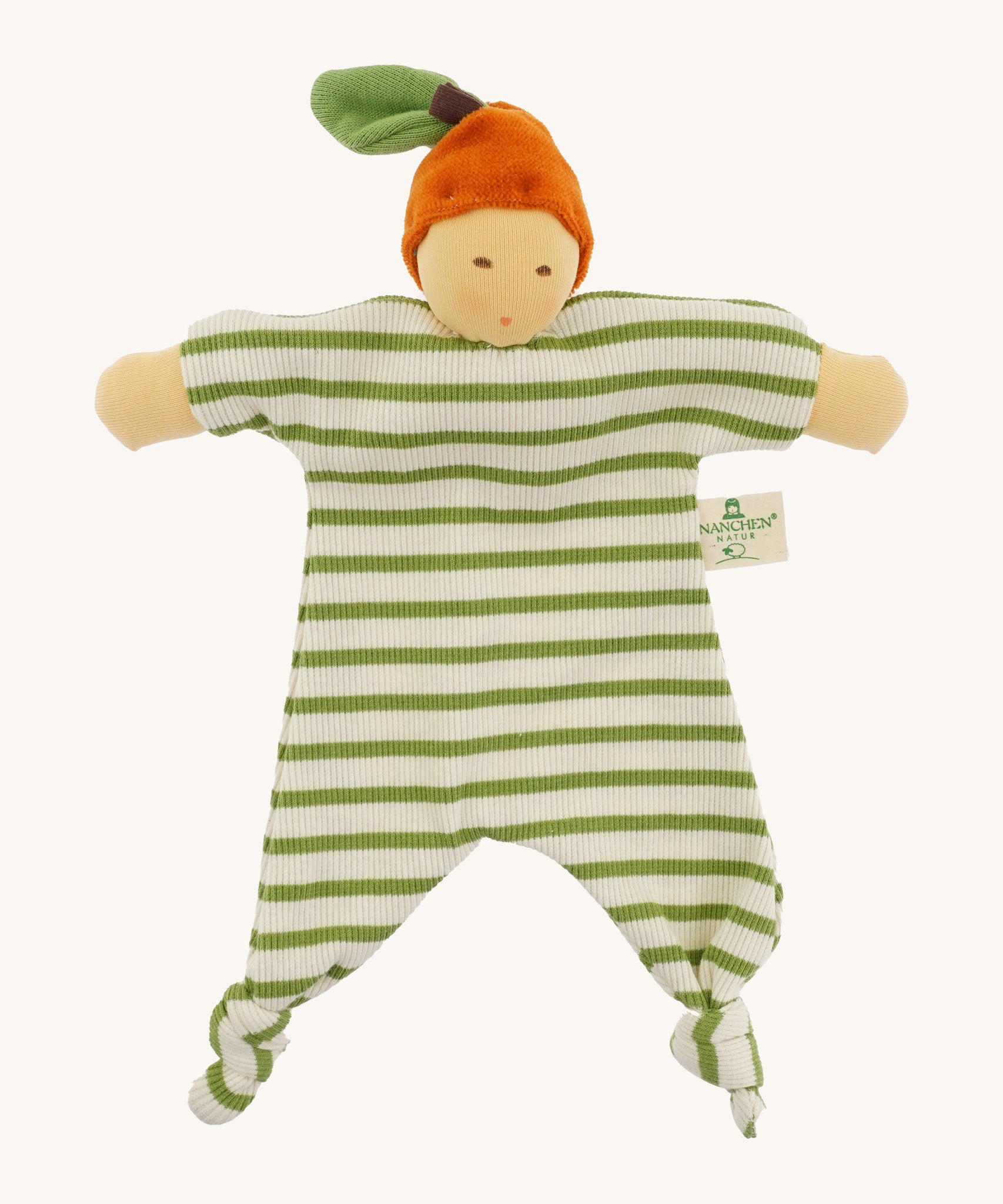 Front view of the Nanchen Orange Baby Comforter, a handcrafted doll with a natural-toned face and an orange velour fruit-inspired hat topped with a green leaf. The body is made of green and white striped organic cotton terry with knotted feet and extended arms, and includes a "Nanchen Natur" brand tag.