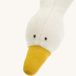 Close-up of the goose’s head on the Nanchen Baby Comforter, showing hand-stitched black eyes, soft terry fabric, and a mustard yellow beak. The wool-stuffed head contrasts with the flat, unstuffed body.