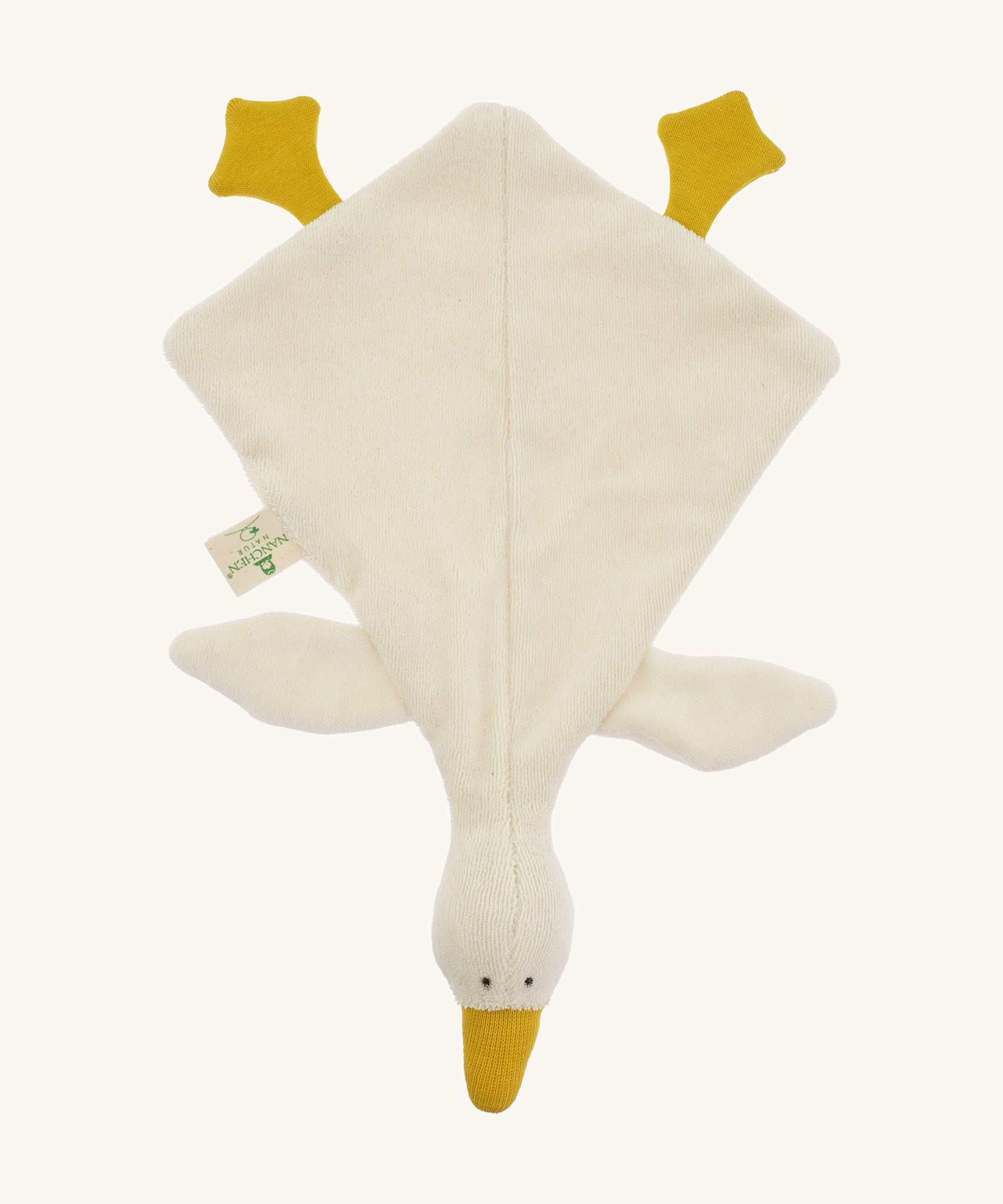Top view of the Nanchen White Goose Baby Comforter. The soft wool-stuffed head features simple stitched eyes, a mustard yellow beak, and floppy wings and feet made from organic cotton.