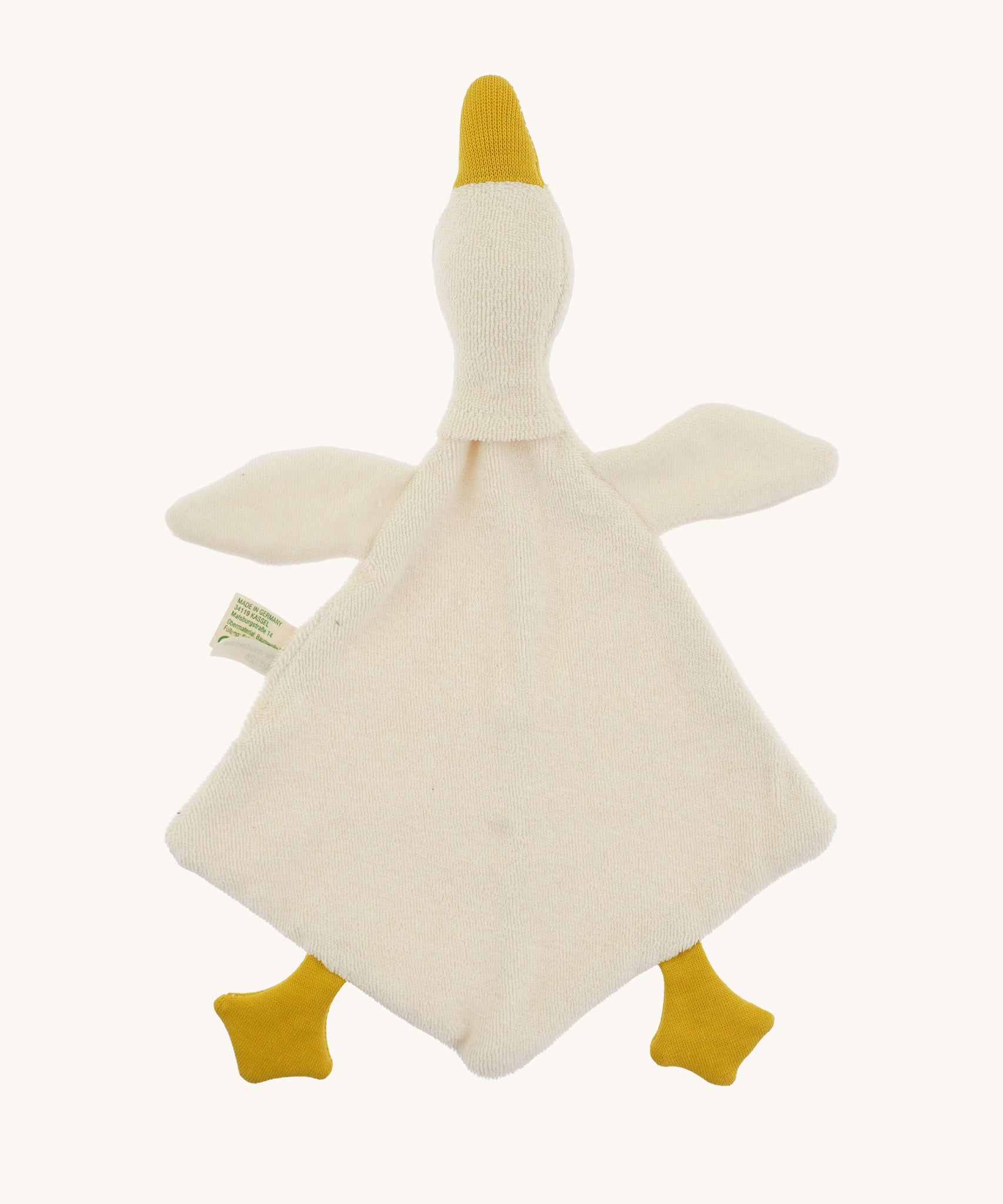 Bottom view of the Nanchen White Goose Baby Comforter, showing its unstuffed, diamond-shaped blanket body made from organic cotton terry. The soft goose head and wings extend from the top, with mustard yellow feet and beak.