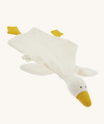 Angled front view of the Nanchen White Goose Baby Comforter laid flat. The soft cream-colored blanket body spreads out with attached yellow feet and a raised plush goose head with a gentle, minimalist expression.