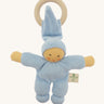 Front view of the Nanchen Pimpel Doll Baby Comforter in soft blue. The baby doll features softly painted facial details, a tall pointed hood, and a knotted footed design, with an attached wooden teething ring.